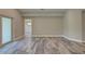 Open living room with sliding door access and gray wood-look tile flooring at 160 Apollo Dr, Rotonda West, FL 33947