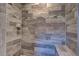 Modern shower with wood-look tile and decorative accent tile at 160 Apollo Dr, Rotonda West, FL 33947