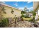 Charming stone patio with seating area and lush landscaping at 2057 Garden Pkwy, Bradenton, FL 34205