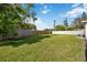 Large grassy backyard with wood fence and partial view of house at 2057 Garden Pkwy, Bradenton, FL 34205