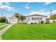 Charming ranch house with a well-manicured lawn and attached garage at 2057 Garden Pkwy, Bradenton, FL 34205