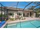 Lush landscaping surrounds this screened pool and patio area at 2123 Timucua Trl, Nokomis, FL 34275