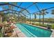 Relaxing screened pool with canal views and lush landscaping at 2123 Timucua Trl, Nokomis, FL 34275