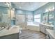 Bathroom with a large soaking tub, walk-in shower, and double vanity at 228 36Th Ne St, Bradenton, FL 34208