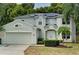 Two-story house with a green facade, solar panels, and a well-maintained lawn at 228 36Th Ne St, Bradenton, FL 34208