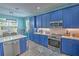Modern kitchen with blue cabinets, stainless steel appliances, and white quartz countertops at 228 36Th Ne St, Bradenton, FL 34208