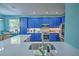 Modern kitchen with blue cabinets, stainless steel appliances, and white quartz countertops at 228 36Th Ne St, Bradenton, FL 34208