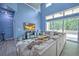 Open-concept living room with large windows, sectional sofa and access to backyard at 228 36Th Ne St, Bradenton, FL 34208