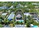 Beautiful aerial view of a modern two-story home with a backyard pool and lush tropical landscaping in a residential neighborhood at 2425 Floyd St, Sarasota, FL 34239