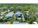 Aerial view of a modern home nestled in a lush, green neighborhood with a private pool and ample space at 2425 Floyd St, Sarasota, FL 34239