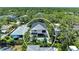 Aerial view of a modern home nestled in a lush, green neighborhood with a private pool and ample space at 2425 Floyd St, Sarasota, FL 34239