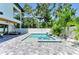 Outdoor living with a lovely pool, patio and seating area surrounded by tropical landscaping at 2425 Floyd St, Sarasota, FL 34239