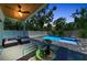 Outdoor area featuring a refreshing pool, inviting patio furniture, and lush landscaping under a wood ceiling at 2425 Floyd St, Sarasota, FL 34239