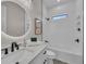 Bright bathroom featuring a modern design, sleek fixtures, and a stylish vanity with marble countertops at 2425 Floyd St, Sarasota, FL 34239