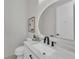 Modern powder room with marble countertop, stylish fixtures and updated toilet at 2425 Floyd St, Sarasota, FL 34239