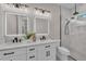 Bathroom features a double vanity, modern lighting, and a glass-enclosed shower at 2425 Floyd St, Sarasota, FL 34239