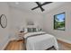 Cozy bedroom showcasing hardwood floors, a comfortable bed, and a scenic view from the window at 2425 Floyd St, Sarasota, FL 34239