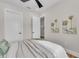 Cozy bedroom with a ceiling fan, relaxing decor, and a glimpse of an adjoining room at 2425 Floyd St, Sarasota, FL 34239