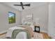 Stylish bedroom with large windows, warm lighting, and relaxing green and brown decor at 2425 Floyd St, Sarasota, FL 34239