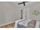 Well-lit bedroom highlighting hardwood floors, a stylish ceiling fan, and ample natural light at 2425 Floyd St, Sarasota, FL 34239