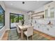 Dining room features a table for six, modern light fixture and access to outdoor pool at 2425 Floyd St, Sarasota, FL 34239