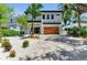 Beautiful home featuring a manicured front yard, modern design, and a spacious driveway at 2425 Floyd St, Sarasota, FL 34239