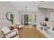 Bright foyer features light hardwood floors, textured accent wall, modern lighting and a sleek front door at 2425 Floyd St, Sarasota, FL 34239