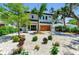 Modern two-story home featuring a manicured front yard with decorative white rock, landscaping, and paver driveway at 2425 Floyd St, Sarasota, FL 34239