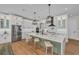Modern kitchen with a large island, breakfast bar seating, and stainless steel appliances at 2425 Floyd St, Sarasota, FL 34239