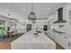 Open-concept kitchen with a marble island, stainless steel appliances, and stylish pendant lighting fixtures at 2425 Floyd St, Sarasota, FL 34239