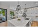 Bright kitchen with a marble island, modern pendant lighting, and stainless steel appliances at 2425 Floyd St, Sarasota, FL 34239