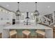 Bright kitchen with large island, pendant lights, bar seating, and modern appliances at 2425 Floyd St, Sarasota, FL 34239