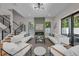 Inviting living room featuring hardwood floors, a modern fireplace, and views of the outdoor pool area at 2425 Floyd St, Sarasota, FL 34239