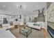 Bright, open-concept living room featuring modern decor and a view of the staircase and kitchen at 2425 Floyd St, Sarasota, FL 34239