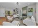 Spacious living room with hardwood floors, fireplace, staircase, modern furniture, and a sleek front door at 2425 Floyd St, Sarasota, FL 34239