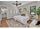 Bright, well-staged bedroom with ensuite bathroom, a ceiling fan, and neutral decor at 2425 Floyd St, Sarasota, FL 34239