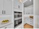 Walk-in pantry featuring custom cabinetry and countertops at 2425 Floyd St, Sarasota, FL 34239