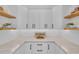 Bright pantry featuring white cabinets, quartz countertops, and wooden shelving at 2425 Floyd St, Sarasota, FL 34239