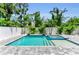 Outdoor area featuring a sparkling pool, stylish patio, and lush greenery surrounding the space at 2425 Floyd St, Sarasota, FL 34239