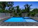 Beautiful pool featuring clear blue water and lush tropical landscaping providing a relaxing backyard oasis at 2425 Floyd St, Sarasota, FL 34239