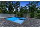 Inviting pool and spa with lovely grey brick and tropical plants around the perimeter at 2425 Floyd St, Sarasota, FL 34239