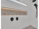 Contemporary shower design featuring pebble tile flooring and a stylish, illuminated wall niche at 2425 Floyd St, Sarasota, FL 34239