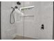 Modern shower with glass enclosure, rain shower head, and light streaming through a window at 2425 Floyd St, Sarasota, FL 34239