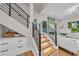 Open staircase featuring wood treads, modern railing and access to the living room at 2425 Floyd St, Sarasota, FL 34239