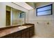 Bathroom features a vanity with brown cabinets and a large mirror at 2711 W Marion Ave, Punta Gorda, FL 33950