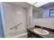Bathroom with tub, shower, and dark vanity at 2711 W Marion Ave, Punta Gorda, FL 33950