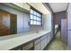 Bathroom with a large vanity, double sinks, and a window at 2711 W Marion Ave, Punta Gorda, FL 33950