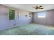 Spacious bedroom with light purple walls, carpet, and ceiling fan at 2711 W Marion Ave, Punta Gorda, FL 33950