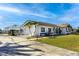 White single-story home with attached garage and landscaping at 2711 W Marion Ave, Punta Gorda, FL 33950