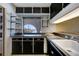 Kitchen features a window with water views, dark cabinets, and a large sink at 2711 W Marion Ave, Punta Gorda, FL 33950